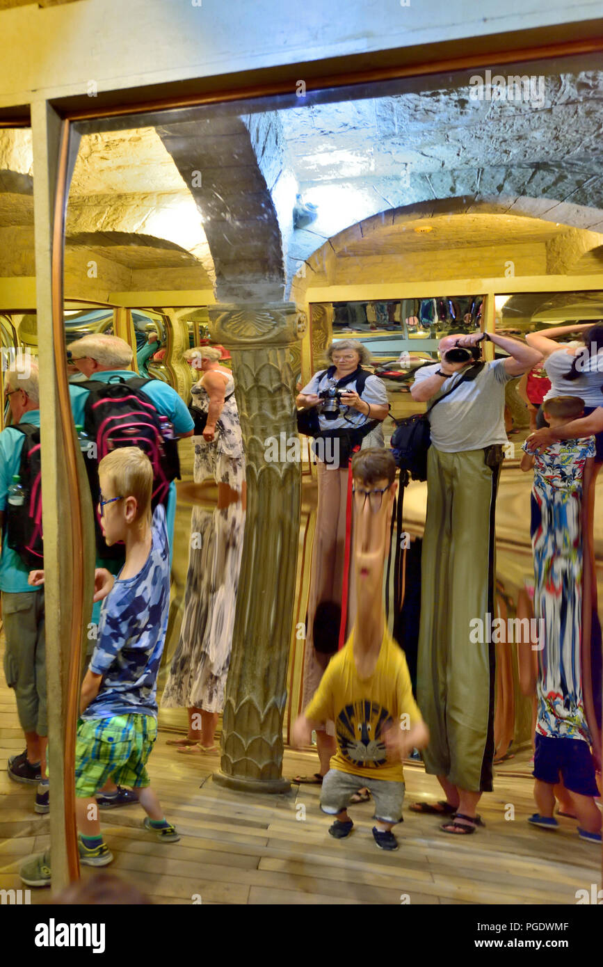 Inside Mirror Maze in Petrin Park with peoples images distorted by the curved mirrors Stock Photo