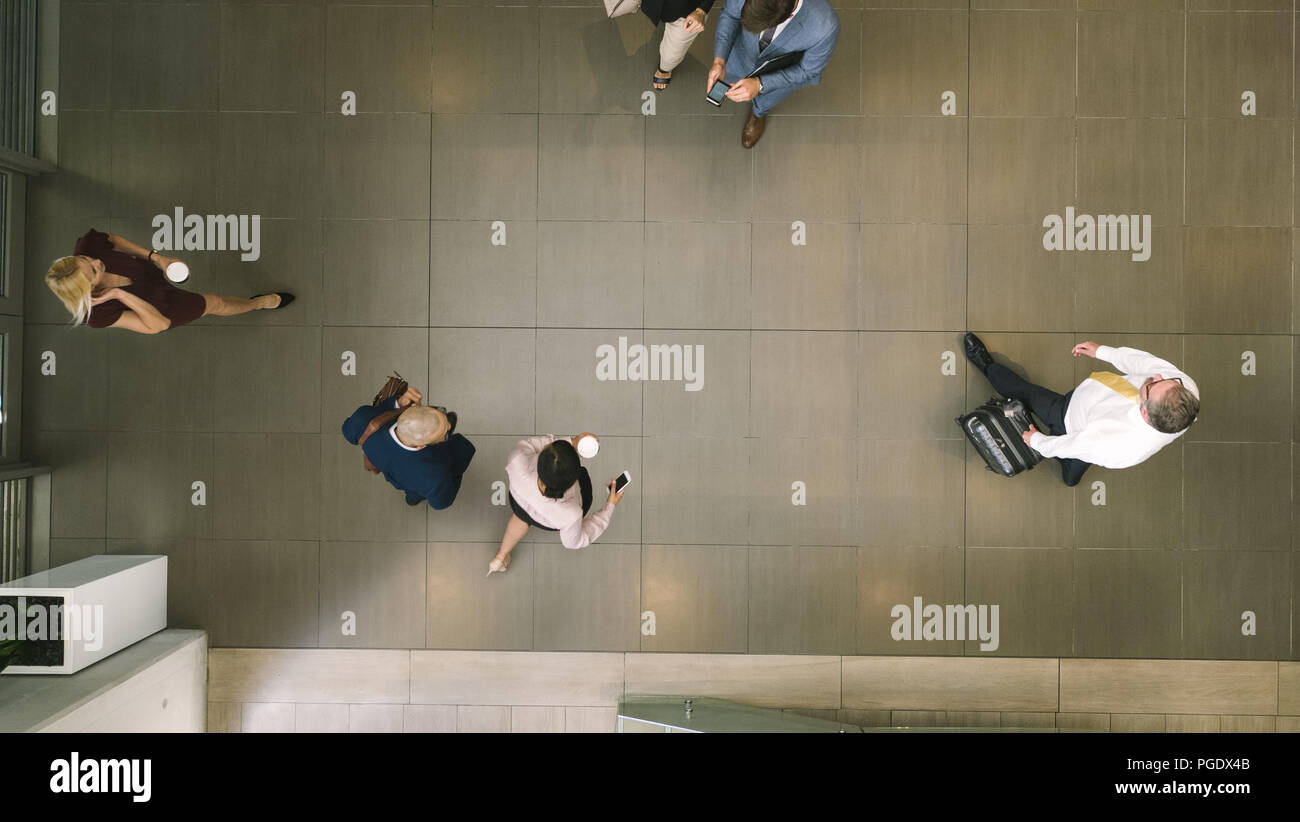 Top view of defocused business people in a lobby. business people walking through a office hallway. Stock Photo