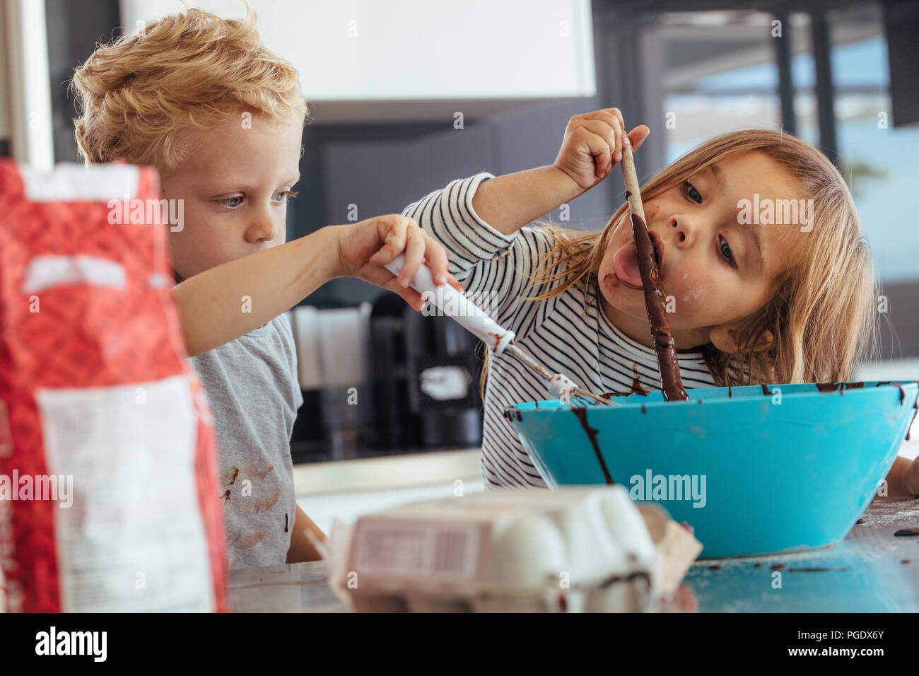 Little Kids Mixing Batter In A Bowl For Baking With Girl Licking A Spoon Children Baking In The Kitchen Stock Photo Alamy