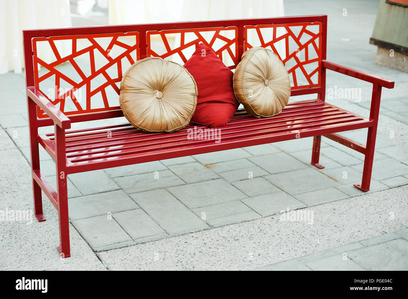 Red asian inspired bench seating with pillows Stock Photo Alamy