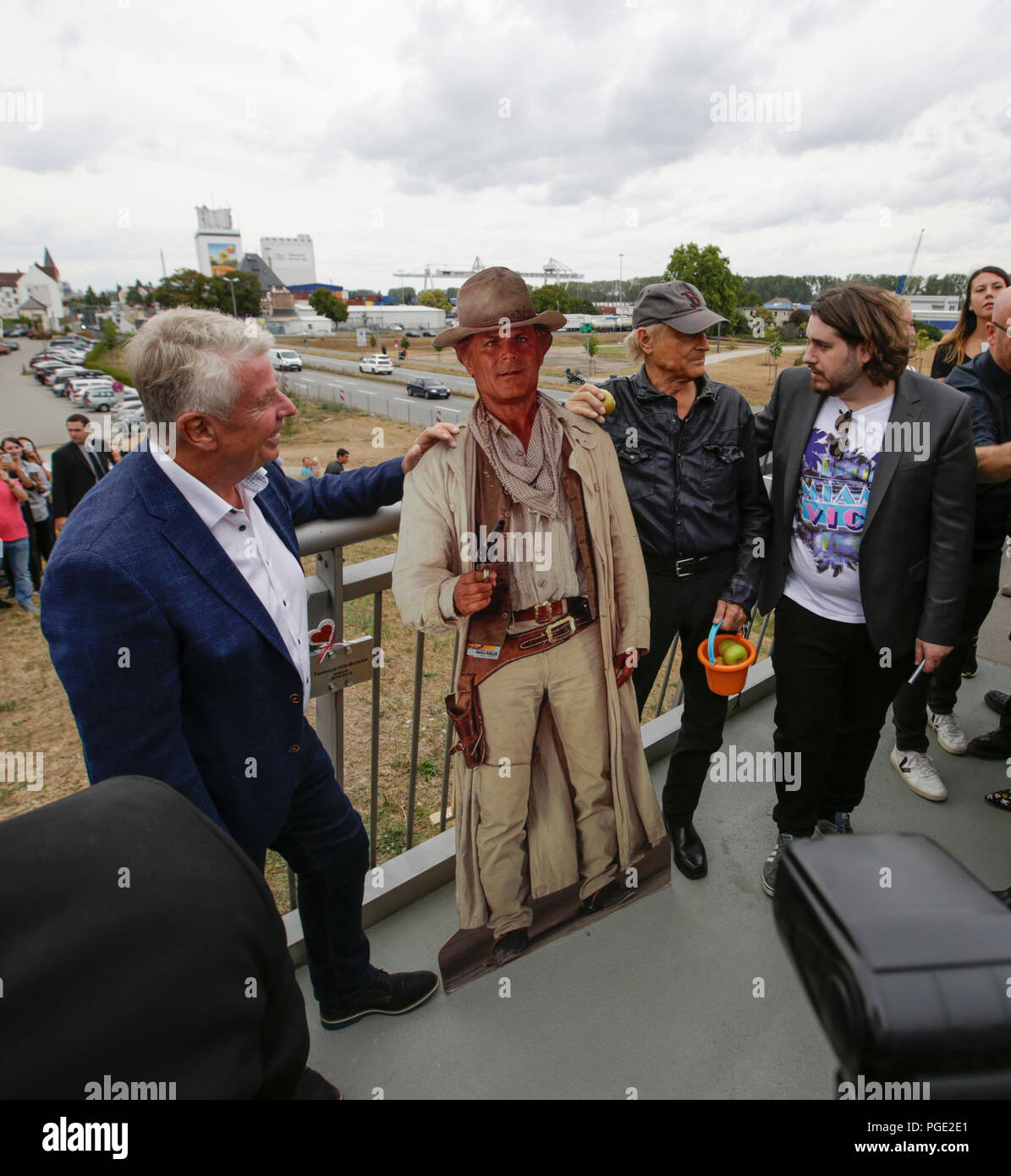 Worms, Germany. 24th Aug, 2018. Actor Peter Englert, who initiated the renaming of the bridge to Terence-Hill-Bridge, Terence Hill and the Lord Mayor of Worms Michael Kissel pose from left to right with a cardboard cut-out of Terence Hill. Italian actor Terence Hill visited the German city of Worms, to present his new movie (My Name is somebody). Terence Hill added the stop in Worms to his movie promotion tour in Germany, to visit a pedestrian bridge, that is unofficially named Terence-Hill-Bridge (officially Karl-Kubel-Bridge). Credit: Michael Debets/Pacific Press/Alamy Live News Stock Photo
