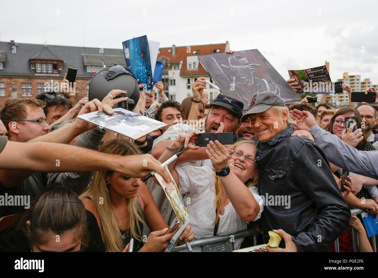 Worms, Germany. 24th Aug, 2018. Terence Hill poses for a picture with his fans. Italian actor Terence Hill visited the German city of Worms, to present his new movie (My Name is somebody). Terence Hill added the stop in Worms to his movie promotion tour in Germany, to visit a pedestrian bridge, that is unofficially named Terence-Hill-Bridge (officially Karl-Kubel-Bridge). Credit: Michael Debets/Pacific Press/Alamy Live News Stock Photo
