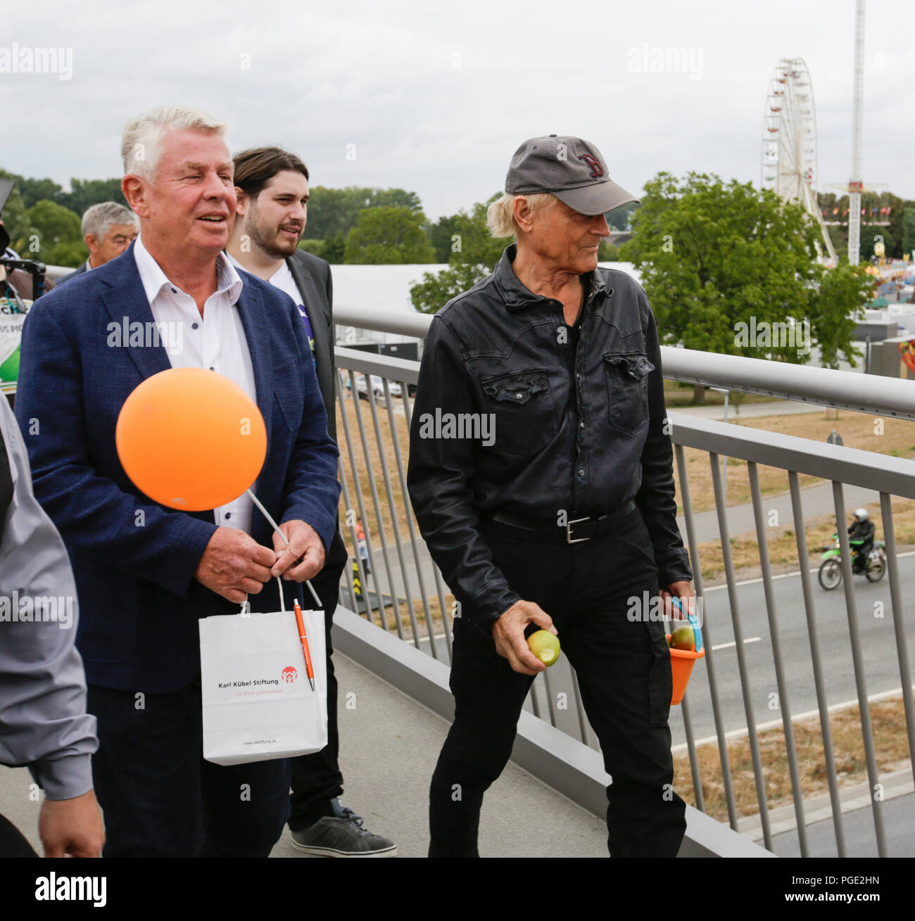 Worms, Germany. 24th Aug, 2018. The Lord Mayor of Worms Michael Kissel (left) and Terence Hill (right) walk over the bridge. Italian actor Terence Hill visited the German city of Worms, to present his new movie (My Name is somebody). Terence Hill added the stop in Worms to his movie promotion tour in Germany, to visit a pedestrian bridge, that is unofficially named Terence-Hill-Bridge (officially Karl-Kubel-Bridge). Credit: Michael Debets/Pacific Press/Alamy Live News Stock Photo
