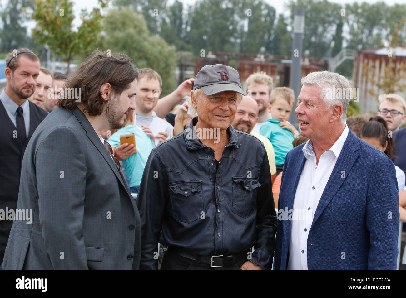 Worms, Germany. 24th Aug, 2018. Actor Peter Englert, who initiated the renaming of the bridge to Terence-Hill-Bridge, Terence Hill and the Lord Mayor of Worms Michael Kissel are pictured from left to right. Italian actor Terence Hill visited the German city of Worms, to present his new movie (My Name is somebody). Terence Hill added the stop in Worms to his movie promotion tour in Germany, to visit a pedestrian bridge, that is unofficially named Terence-Hill-Bridge (officially Karl-Kubel-Bridge). Credit: Michael Debets/Pacific Press/Alamy Live News Stock Photo