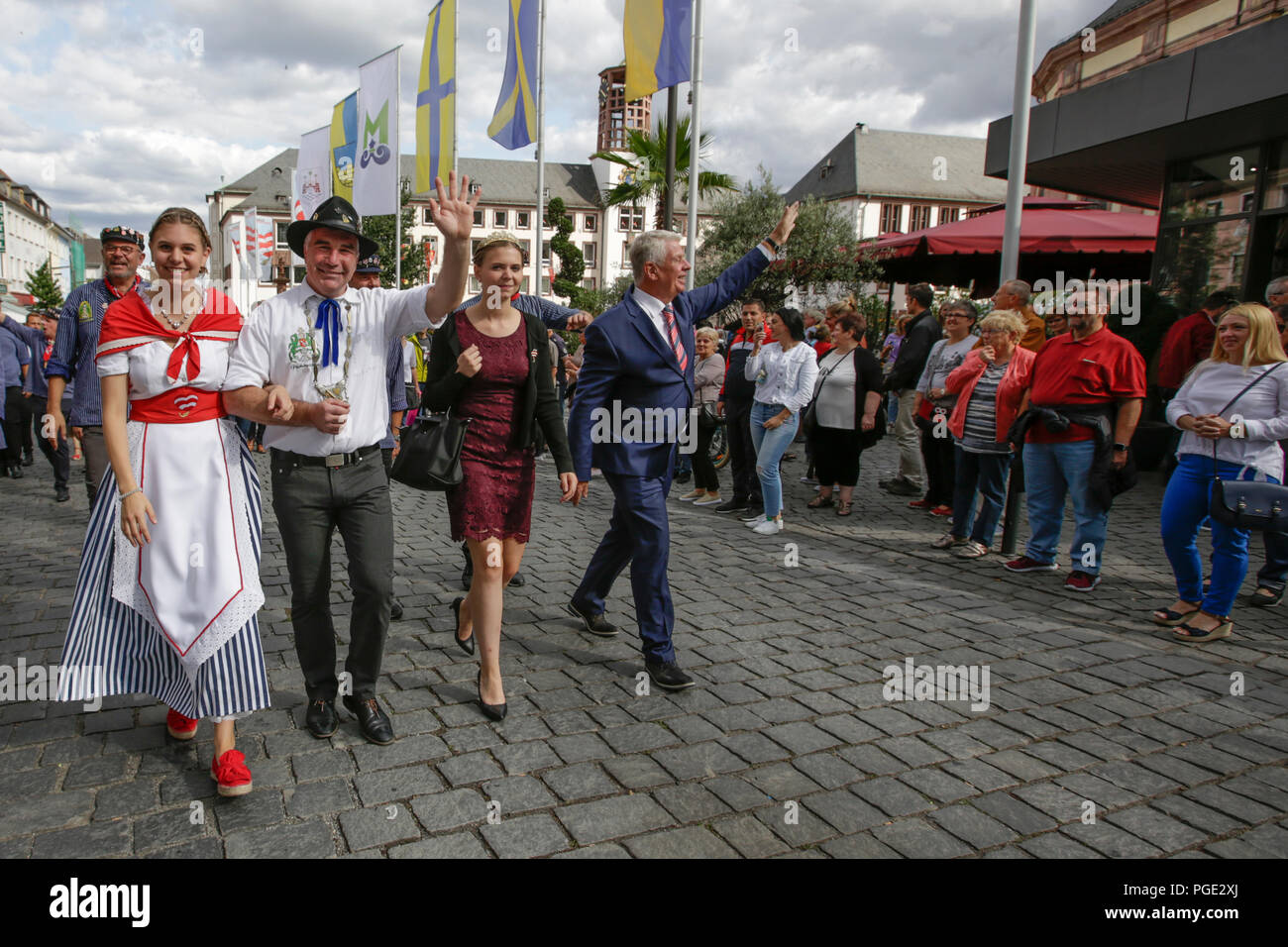 Worms, Germany. 25th Aug, 2018. The Lord Mayor of Worms, Michael Kissel, the Rhine-Hessian wine queen Lea Kopp, Bojemääschter vun de Fischerwääd (mayor of the fishermen's lea), Markus Trapp, and his bride Beatrice Duda march through the city centre. The largest wine and funfair along the Rhine, the Backfischfest started in Worms with the traditional handing over of power from the Lord Mayor to the mayor of the fishermen's lea. The ceremony was framed by dances and music. Credit: Michael Debets/Pacific Press/Alamy Live News Stock Photo