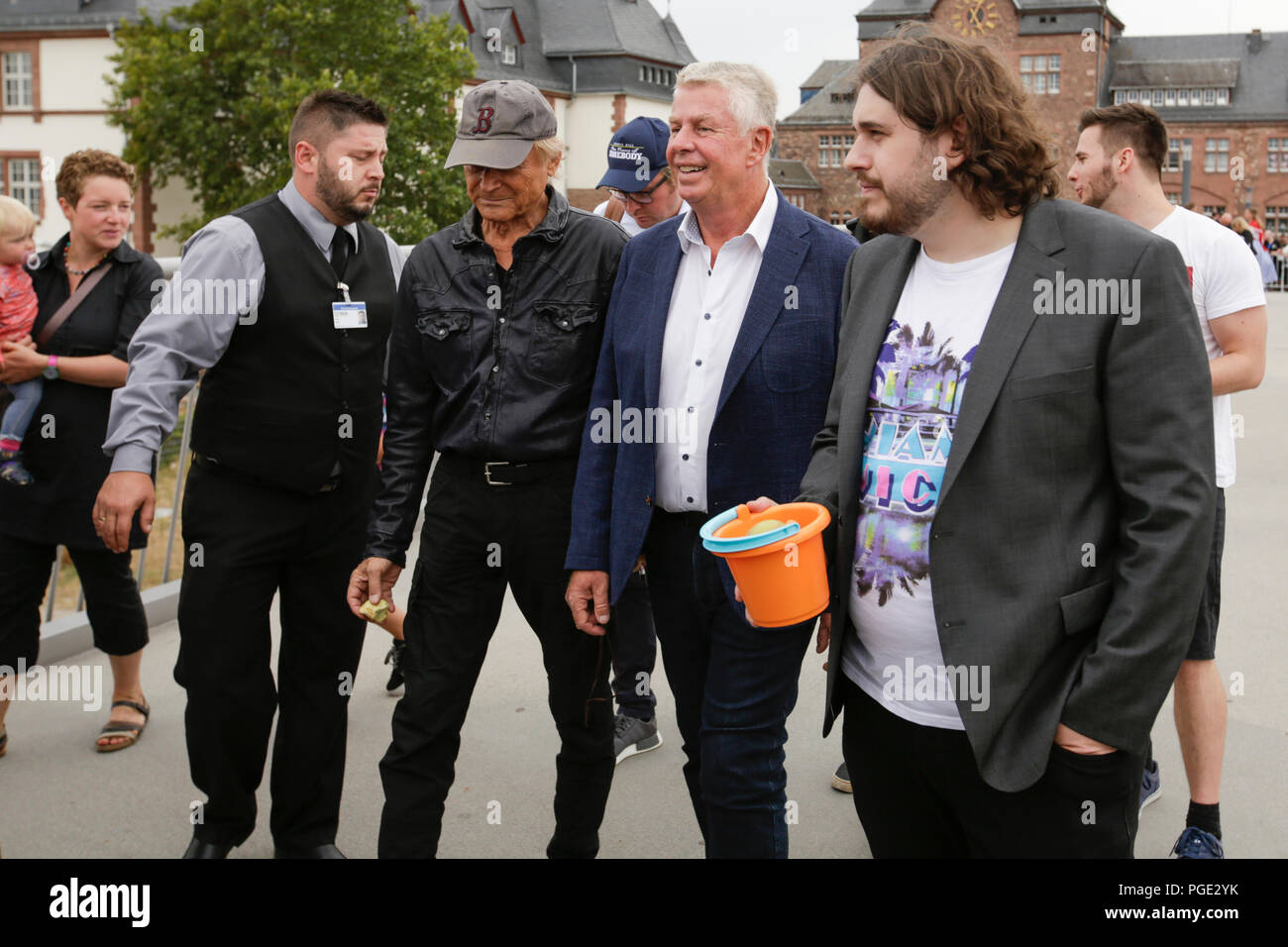 Worms, Germany. 24th Aug, 2018. Terence Hill (2nd left), the Lord Mayor of Worms Michael Kissel (2nd right) and actor Peter Englert (right), who initiated the renaming of the bridge to Terence-Hill-Bridge, walk over the bridge. Italian actor Terence Hill visited the German city of Worms, to present his new movie (My Name is somebody). Terence Hill added the stop in Worms to his movie promotion tour in Germany, to visit a pedestrian bridge, that is unofficially named Terence-Hill-Bridge (officially Karl-Kubel-Bridge). Credit: Michael Debets/Pacific Press/Alamy Live News Stock Photo