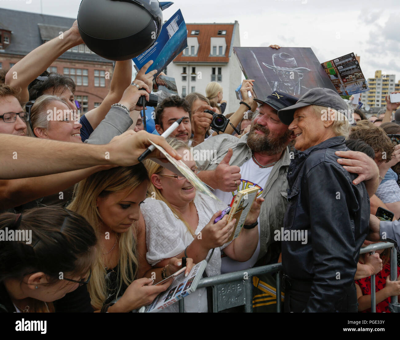 Worms, Germany. 24th Aug, 2018. Terence Hill poses for a picture with a fan, who is a look-alike of his long term film partner Bud Spencer. Italian actor Terence Hill visited the German city of Worms, to present his new movie (My Name is somebody). Terence Hill added the stop in Worms to his movie promotion tour in Germany, to visit a pedestrian bridge, that is unofficially named Terence-Hill-Bridge (officially Karl-Kubel-Bridge). Credit: Michael Debets/Pacific Press/Alamy Live News Stock Photo