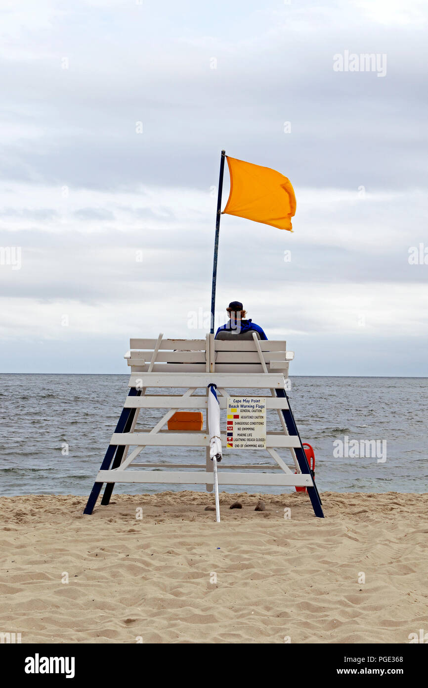 A Cape May Point lifeguard station flying a yellow caution flag concerning swimming in the Atlantic Ocean. Cape May Point, New Jersey, USA Stock Photo