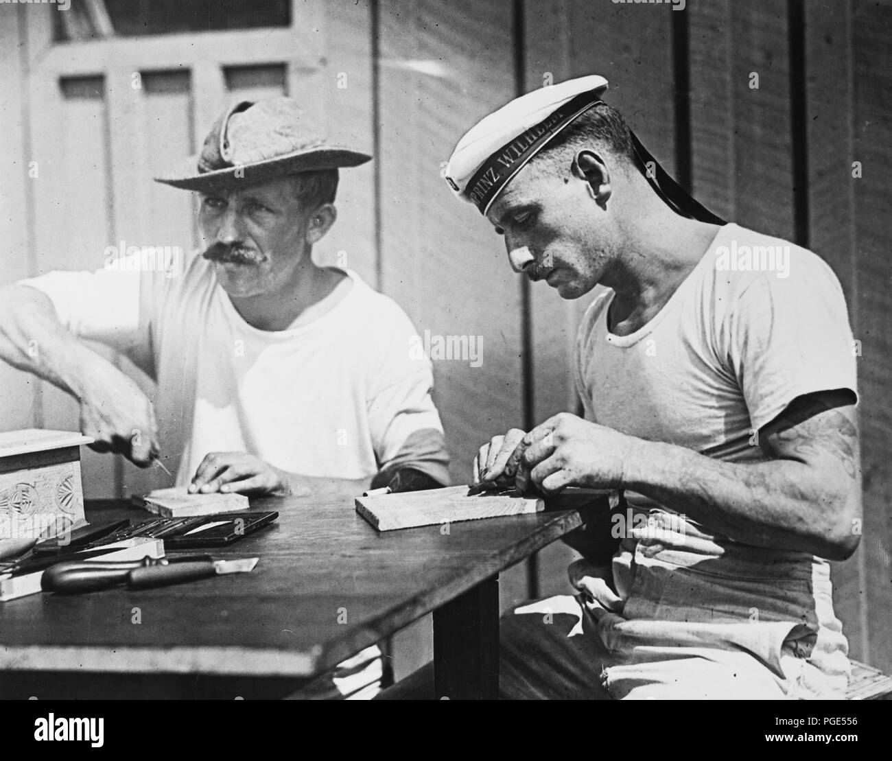 Germans at the war prison camp Fort McPherson, Georgia, carving wooden boxes that are sold through the prison camp. The proceeds are used to buy tobacco and other luxuries for the interned men April 1918 Stock Photo