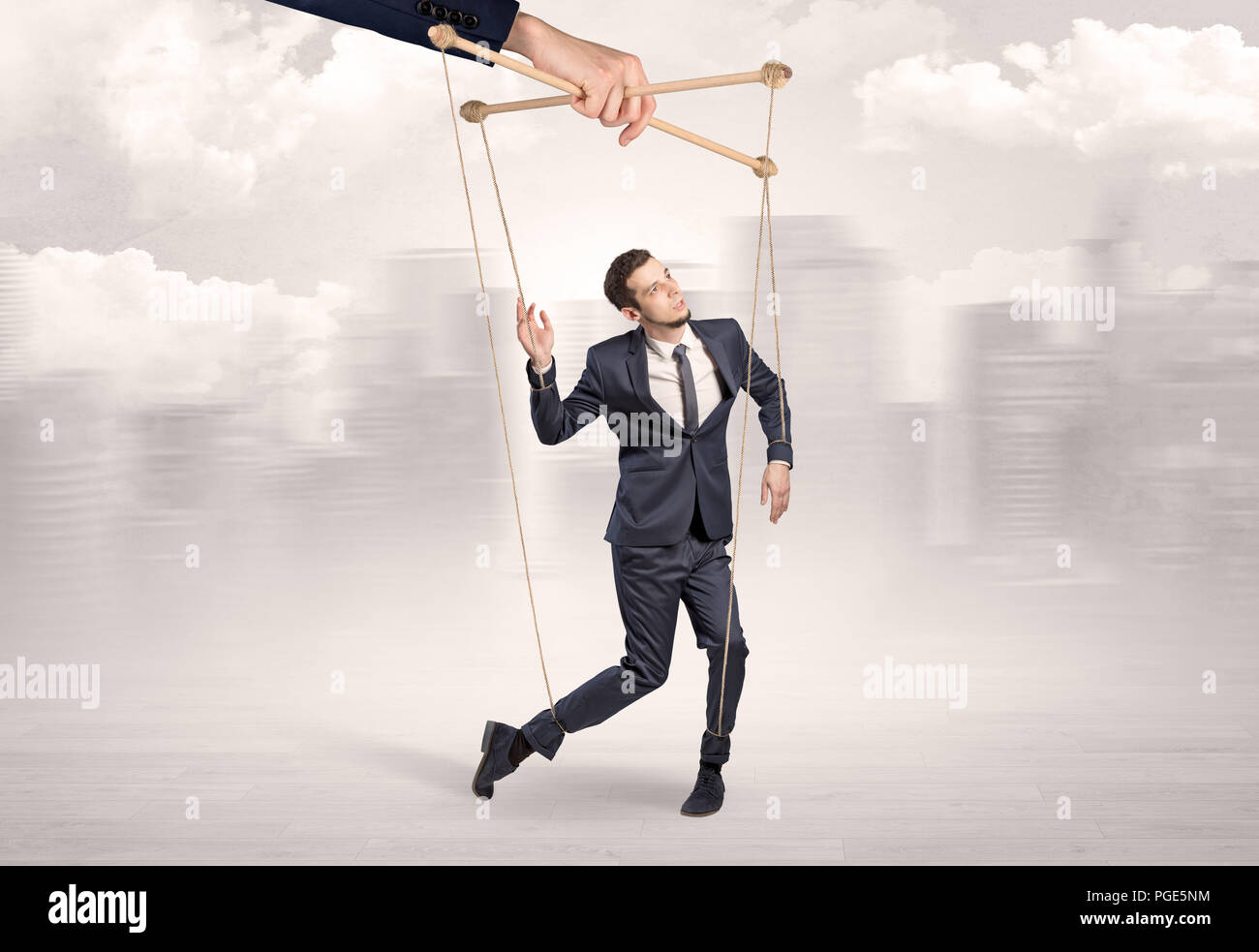 Puppet man with big city great power concept Stock Photo - Alamy
