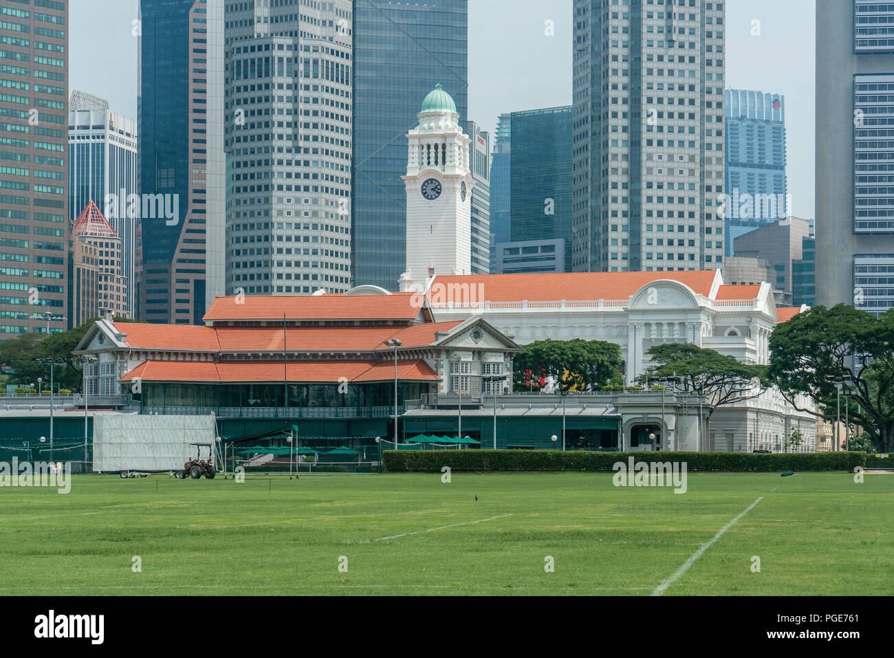 Singapore  - May 21, 2018: Singapore Cricket Club with grass lawn in front and Financial district in the back Stock Photo