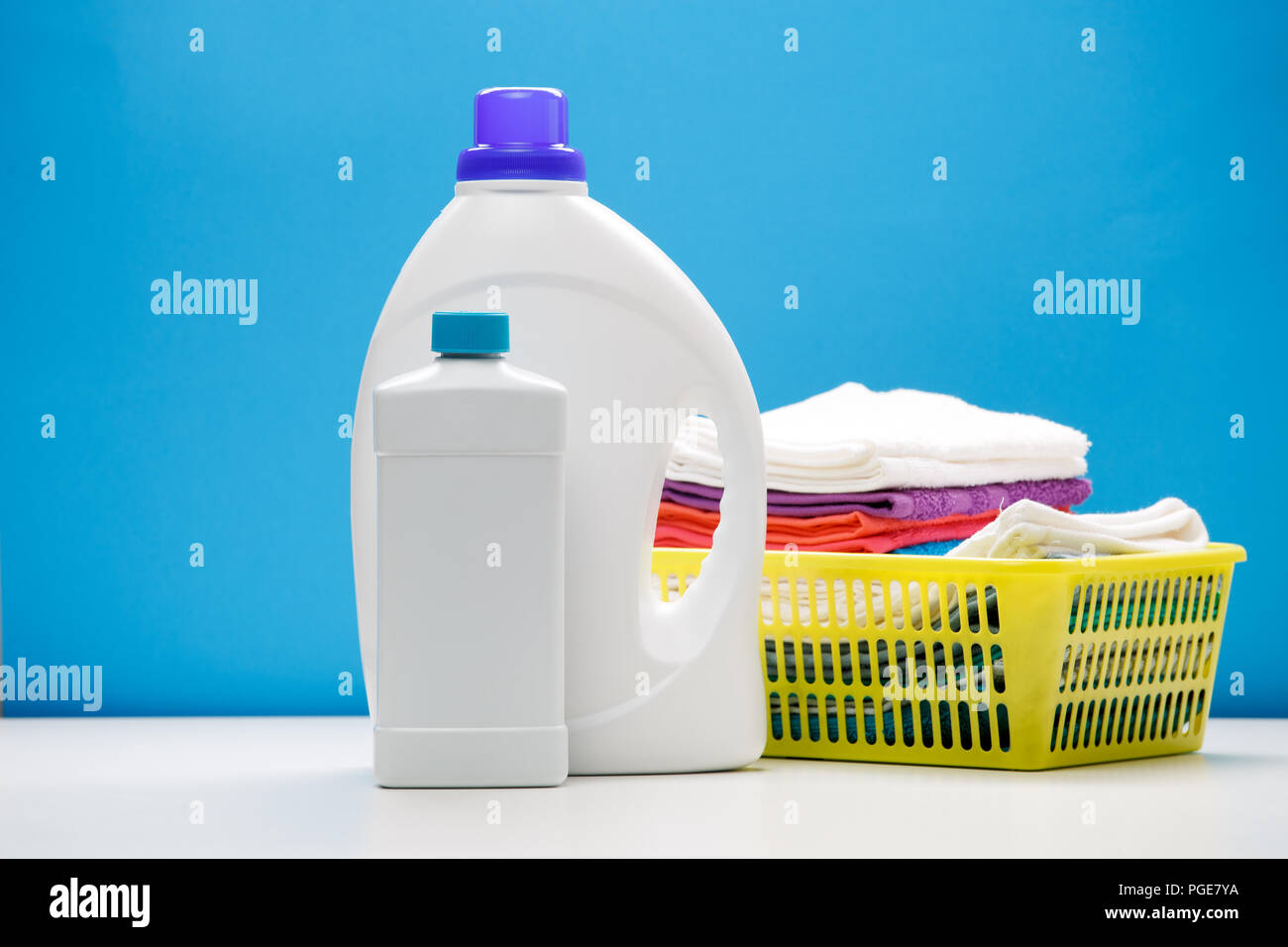 Photo of two bottles of cleansers and yellow basket with towels Stock Photo