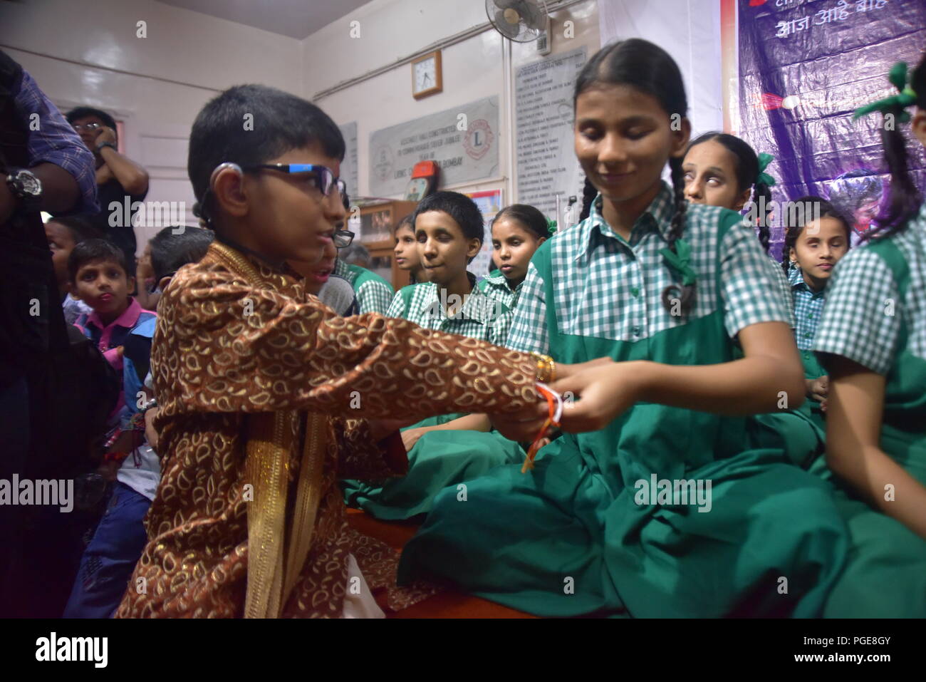 Mumbai, India. 24th Aug, 2018. Raksha Bandhan ceremony at Shreemati Kamla Mehta Dadar School for the Blind. During the ceremony blind kids tie Rakhi (thread of brother sister bonding) to Deaf and Mute kids of Sadhana School for Deaf and Mute in Mumbai. Credit: Sandeep Rasal/Pacific Press/Alamy Live News Stock Photo