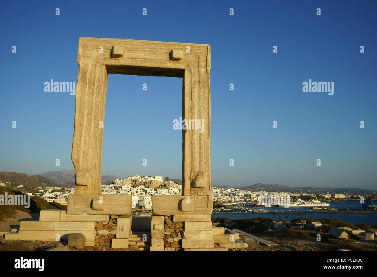 Town Naxos with Portara at sunset, Island Naxos, Greece Stock Photo