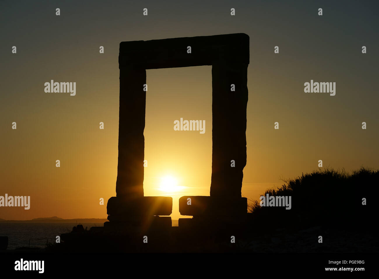 Silhouette of Portara with setting sun, Island Naxos, Cyclades, Greece Stock Photo