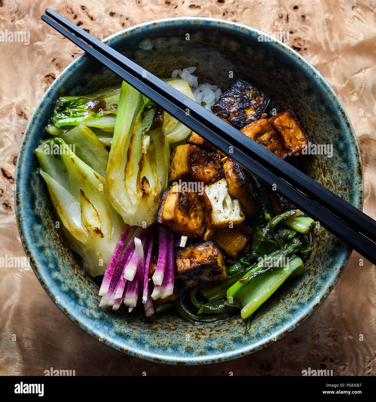 Fivespice crispy tofu with seared bok choy served in a blue and brown