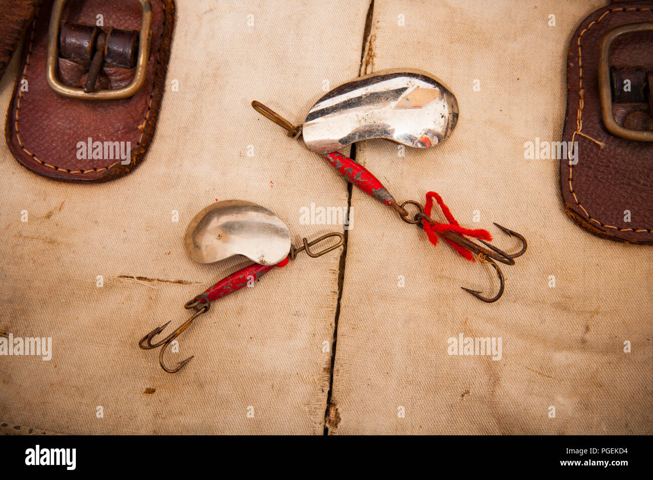 Two metal lures known as kidney spoons due to their shape with treble hooks  displayed on an old fishing tackle bag. From a collection of vintage fishi  Stock Photo - Alamy