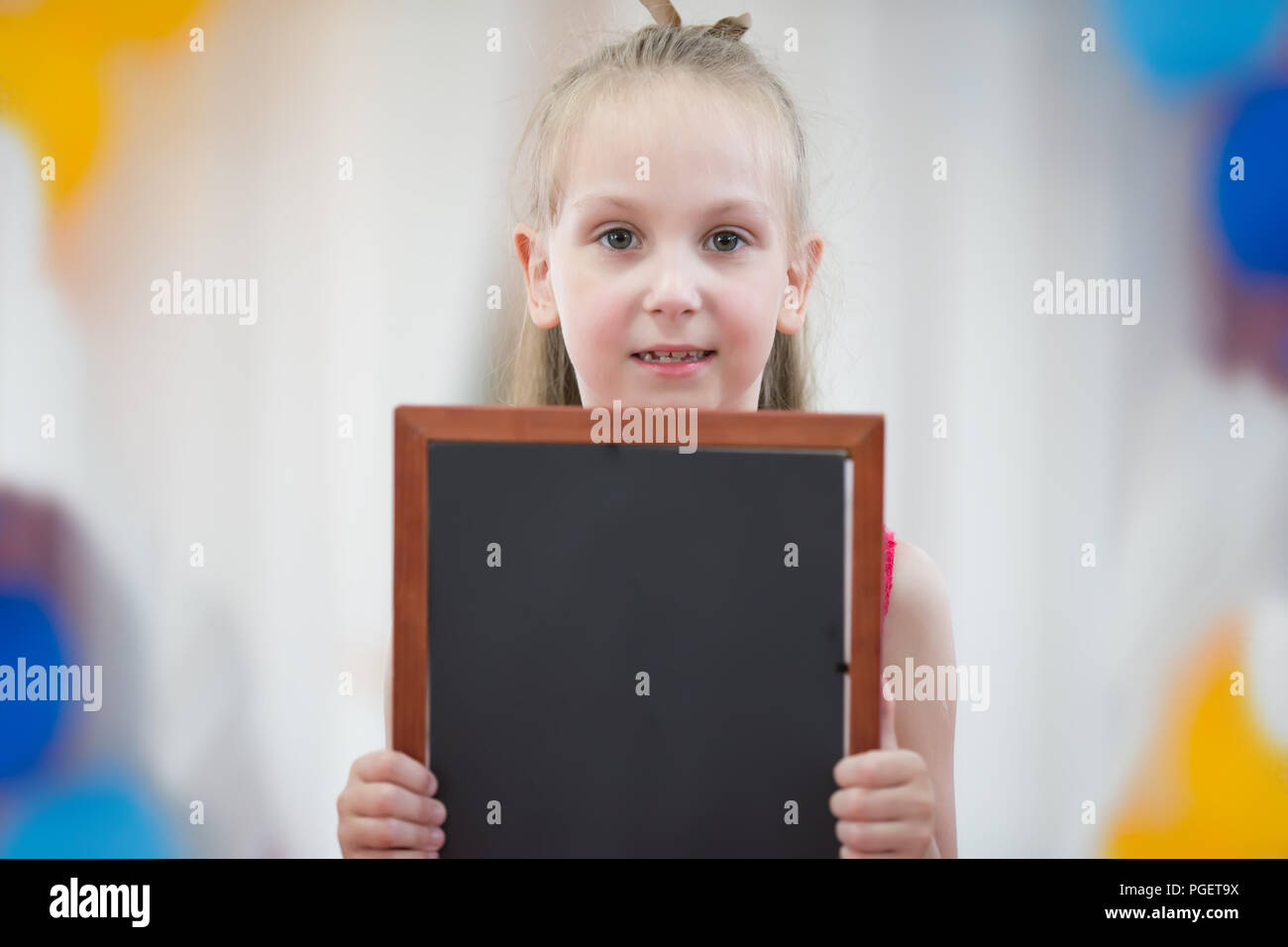 Belarus, Gomel, May 29, 2018. The kindergarten is central. Open Day.The girl is holding a graphic board Stock Photo