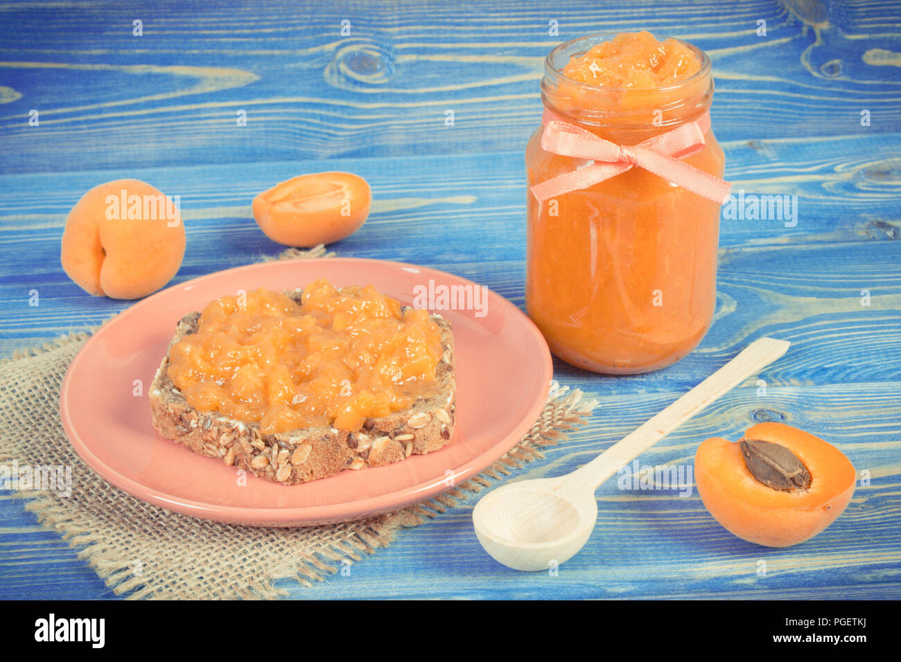 Vintage photo, Fresh prepared sandwich with homemade apricot marmalade and ripe fruits, concept of healthy sweet snack Stock Photo