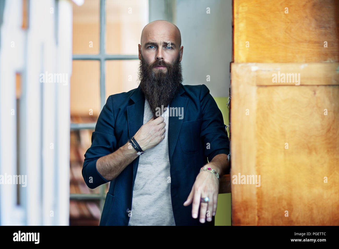 Portrait of bearded thoughtful man strokes beard. Confident concept Stock Photo