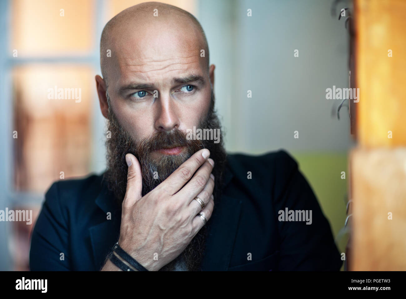 Portrait of bearded thoughtful man strokes beard. Confident concept Stock Photo