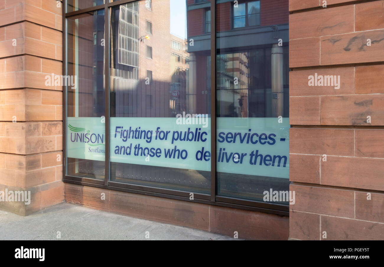 Window of Unison House, office of the Unison public service trade union, in central Glasgow, Scotland. Logo and mission statement: 'Fighting for publi Stock Photo