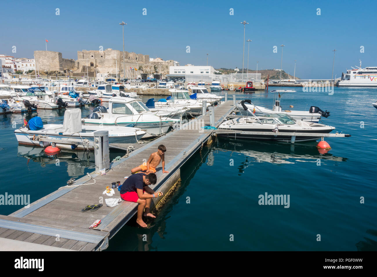 Tarifa Spain. Sail boats and motorboats in Marina of Tarifa, leisure port, Ferry port behind, Costa de la Luz, Andalusia, Spain. Stock Photo