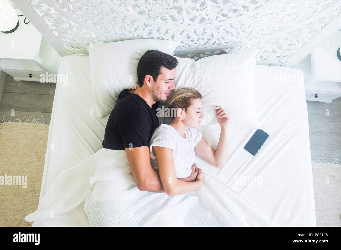aerial view of beautiful caucasian young beautiful couple sleeping at