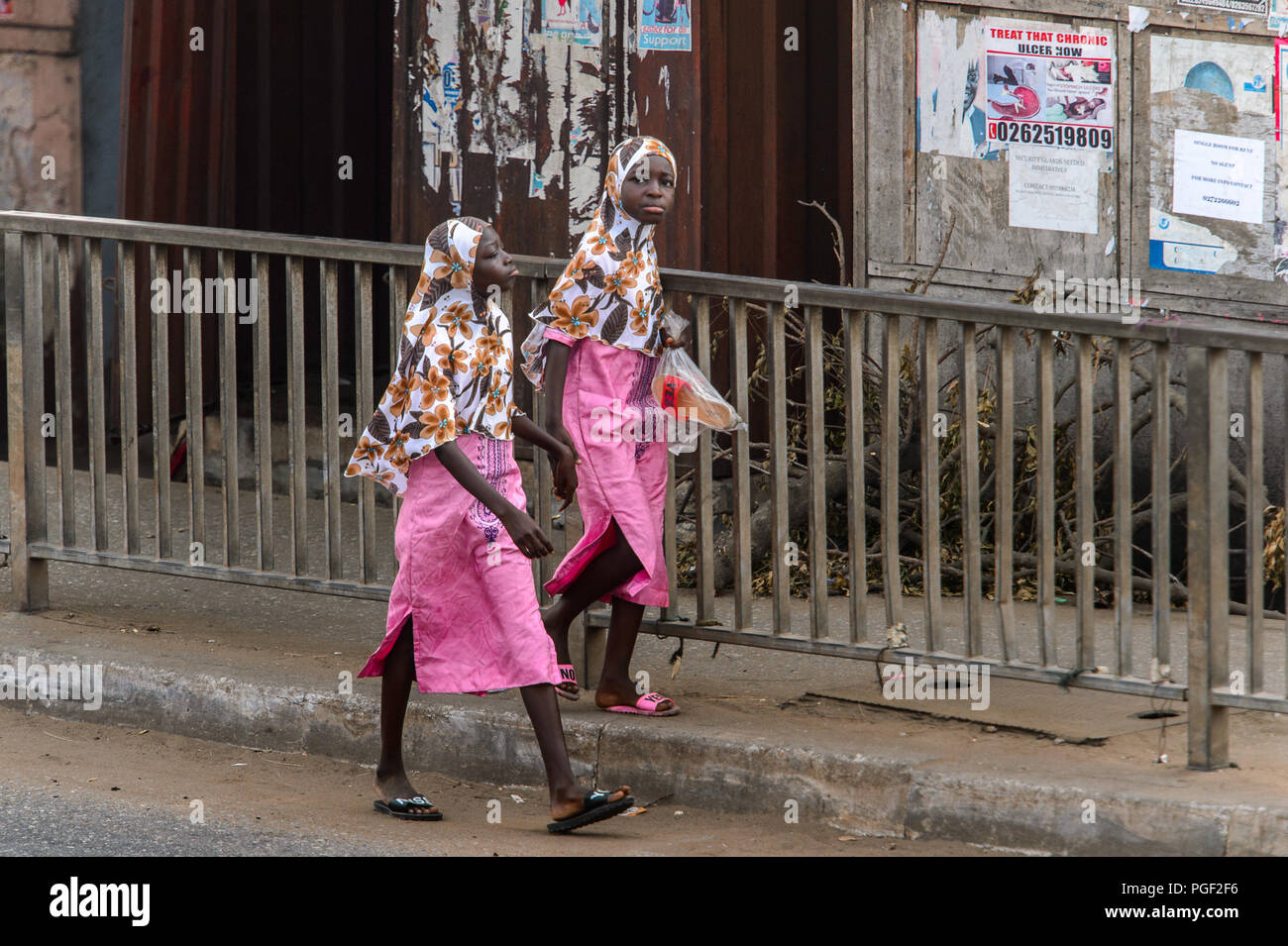 ACCRA, GHANA - JAN 8, 2017: Unidentified Ghanaian two girls wear hijab and pink skirts . Children of Ghana suffer of poverty due to the economic situa Stock Photo