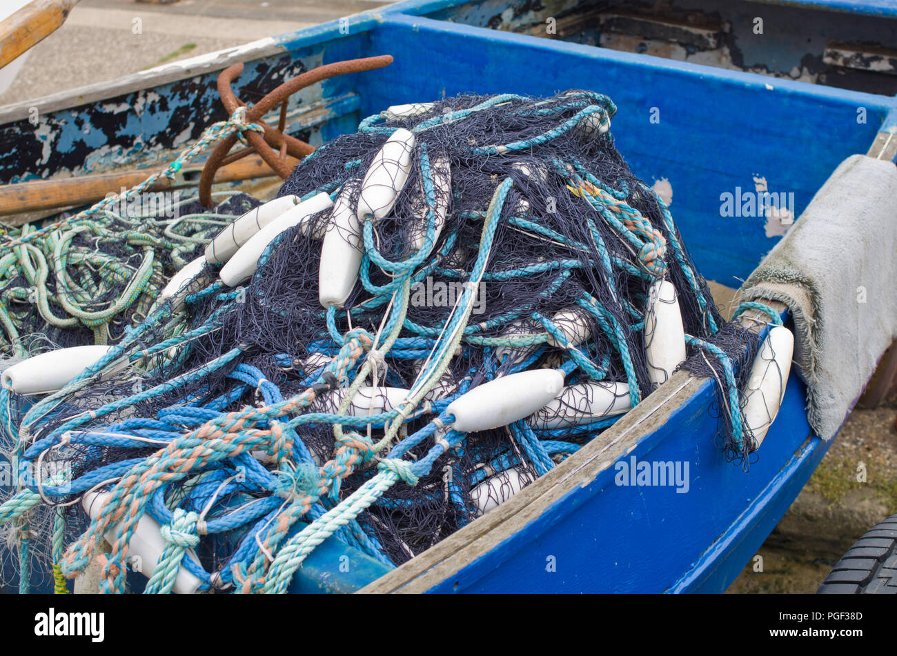 Fishing Nets in Small Inshore Fishing Boat UK Stock Photo
