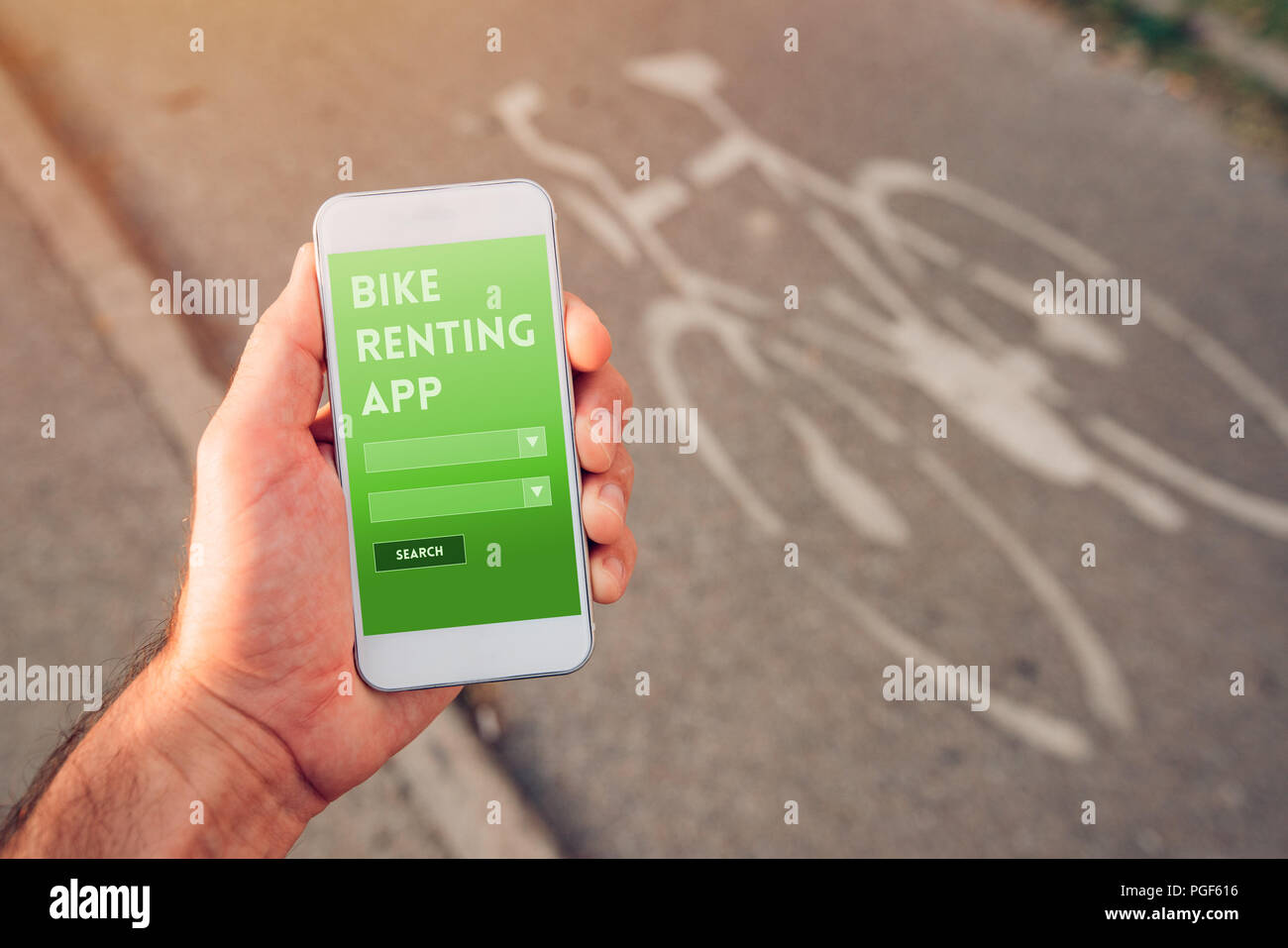 Bike renting app for mobile devices, male hand holding smartphone with