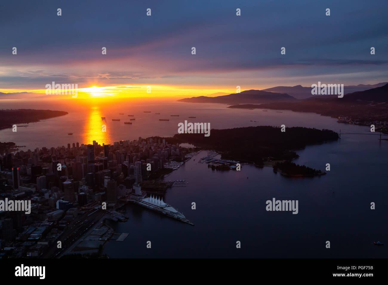 Aerial view of Downtown City during a striking and dramatic sunset ...