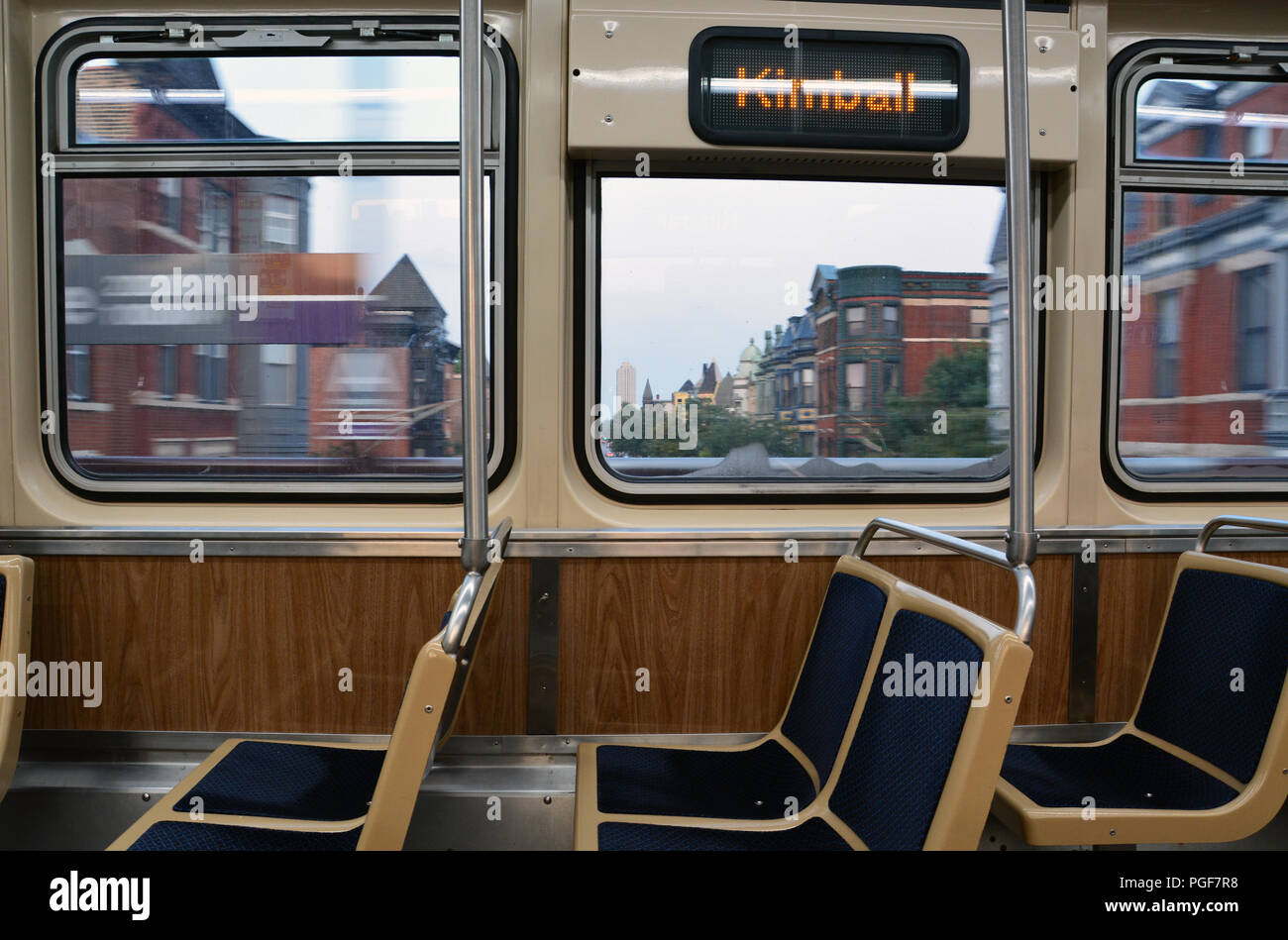 The north side neighborhoods move by outside the windows of an empty