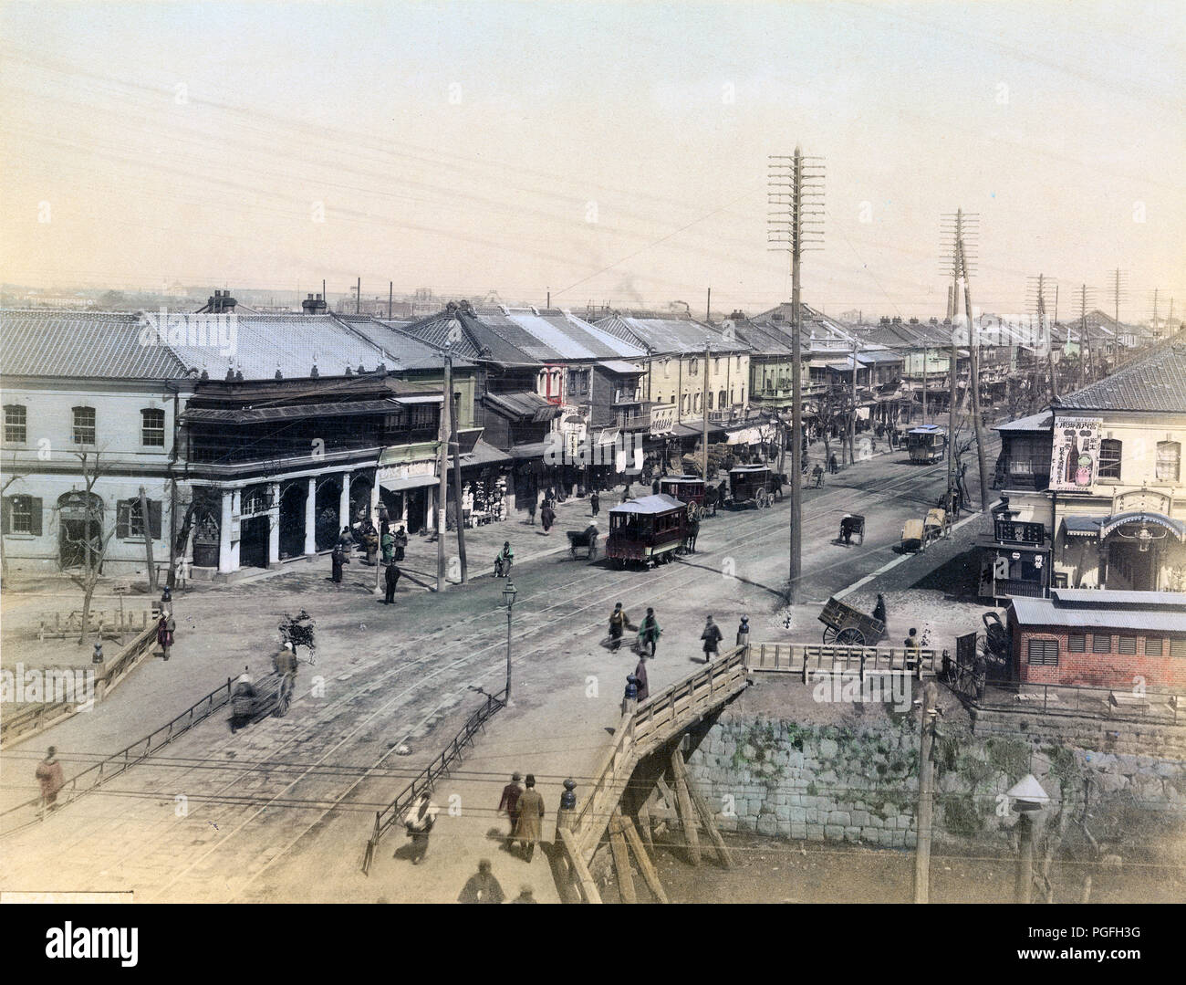 [ c. 1880s Japan - Shinbashi, Tokyo ] —   A view on the Shinbashi (also Shimbashi) bridge and Ginza avenue in Tokyo, sometime between 1882 and 1899. The wooden bridge over the Shiodomegawa (Shiodome River) was replaced with an iron bridge in April 1899.  19th century vintage albumen photograph. Stock Photo