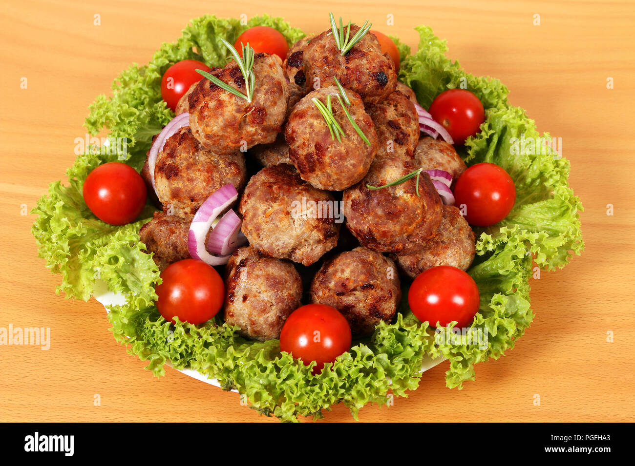 meatballs with tomatoes and salad on plate Stock Photo