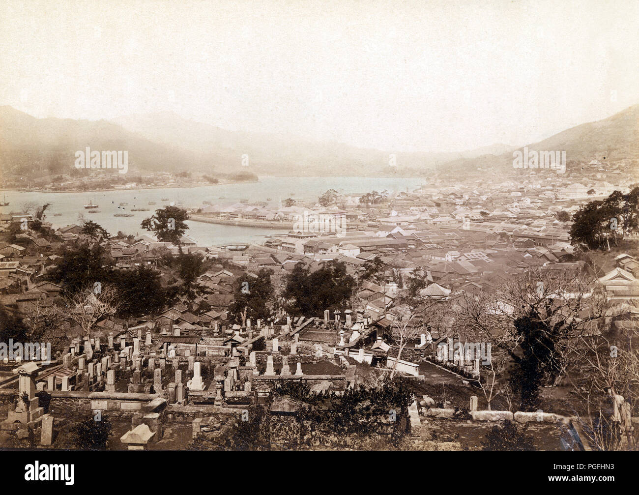 [ c. 1880s Japan - Nagasaki Harbor ] —   View on the Oura Foreign Settlement, Dejima and Nagasaki Harbor from a graveyard in Nagasaki.  19th century vintage albumen photograph. Stock Photo