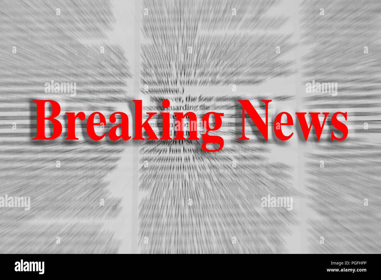 Breaking news written in red with a newspaper article blurred in the background Stock Photo