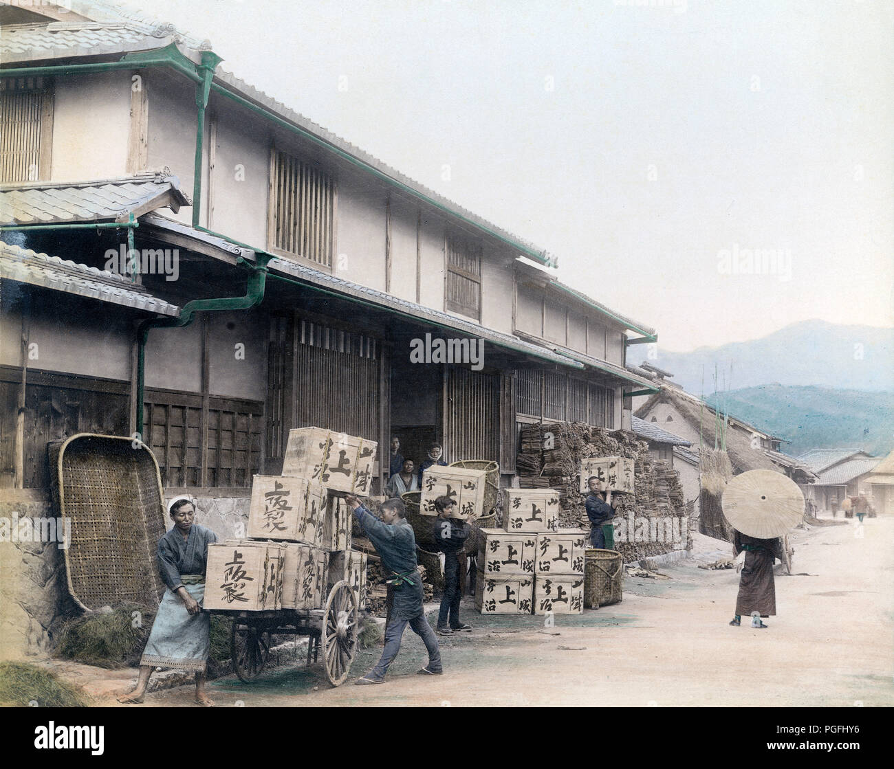 [ c. 1890s Japan - Tea Industry ] —   Workers are loading boxes of tea on a daihachi cart in front of a tea warehouse.   19th century vintage albumen photograph. Stock Photo