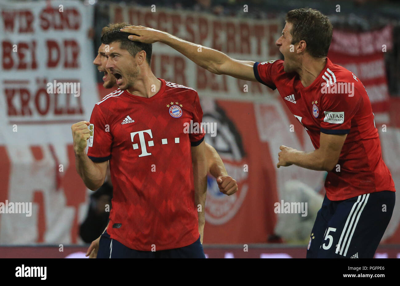 24.08.2018,1.BL, 1.Matchday,  FC Bayern Muenchen vs TSG Hoffenheim,  Allianz Arena Munich, Football, Sport,  im Bild:   Scorer Robert Lewandowski (FCB) celebrate with Leon Goretzka (FCB) and Thomas Mueller (FCB)  DFL REGULATIONS PROHIBIT ANY USE OF PHOTOGRAPHS AS IMAGE SEQUENCES AND / OR QUASI VIDEO.  Copyright: Philippe Ruiz  Handy: 0177 29 39 408 Stock Photo