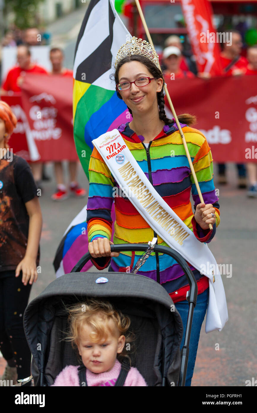 Hastings, East Sussex, UK. 26th Aug, 2018. Hastings pride and festival parade celebrates diversity in this seaside town on the south east coast. This years theme is no discrimination, no alienation. The event runs from 11am until late in the evening. A woman dressed in gay pride rainbow colours pushes a pushchair with toddler. © Paul Lawrenson 2018, Photo Credit: Paul Lawrenson / Alamy Live News Stock Photo
