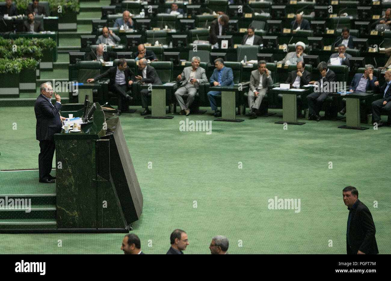 Tehran, Iran. 26th Aug, 2018. Massoud Karbasian (L) speaks during his impeachment process at the Iranian Parliament in Tehran, Iran, Aug. 26, 2018. Iranian lawmakers on Sunday impeached minister of economic affairs and finance over his mismanagement of the current economic situation, official IRNA news agency reported. The former minister Massoud Karbasian lost vote of confidence in the parliament, with 137 out of 260 votes in favor of his impeachment. Credit: Ahmad Halabisaz/Xinhua/Alamy Live News Stock Photo
