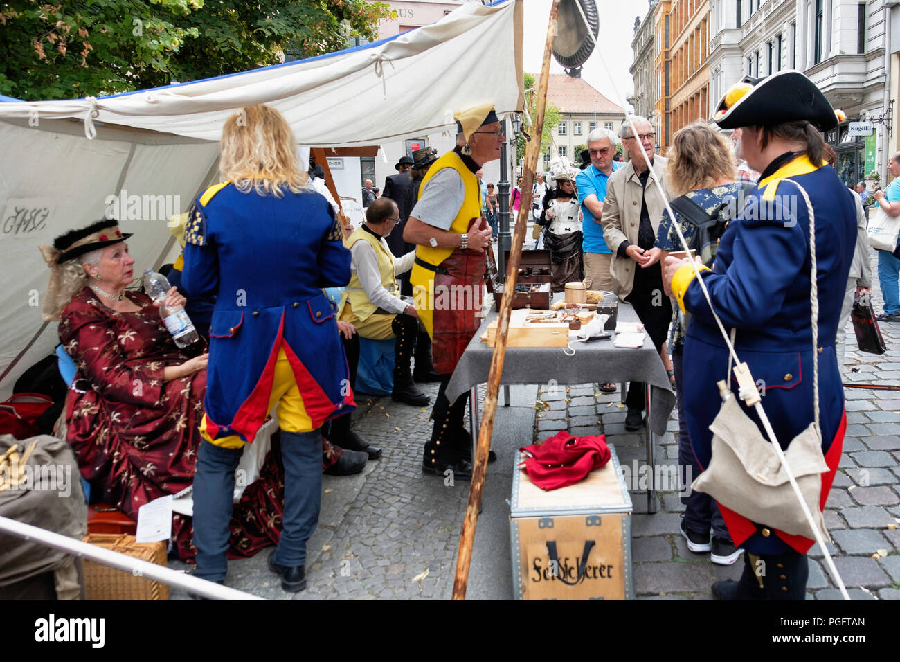 Berlin, Germany. 25 August 2018.  Nikolai Festival, Nikolaifestpiele, historic festival relates the history of Berlin from the Rococo to the Industrial era. The fifth Nikolai Festival entertains with street music, plays & poetry and people wearing period dress visit the Nikolai quarter. The historic market square has numerous stalls displaying traditional crafts and goods. Credit: Eden Breitz/Alamy Live News Stock Photo