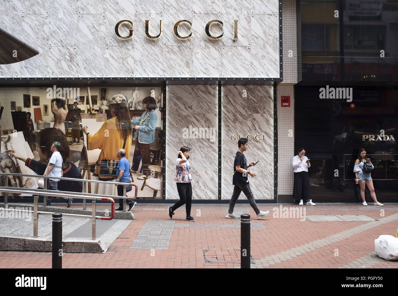 Hong Kong Island, Hong Kong. 24th Aug, 2018. Pedestrians seen walking by a  luxury fashion clothing