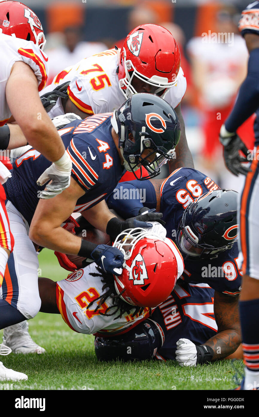 Illinois, USA. 25 August 2018. Chiefs #27 Kareem Hunt is tackled by Bears  #44 Nick Kwiatkoski and #95 Roy Robertson-Harris during the NFL Game  between the Kansas City Chiefs and Chicago Bears