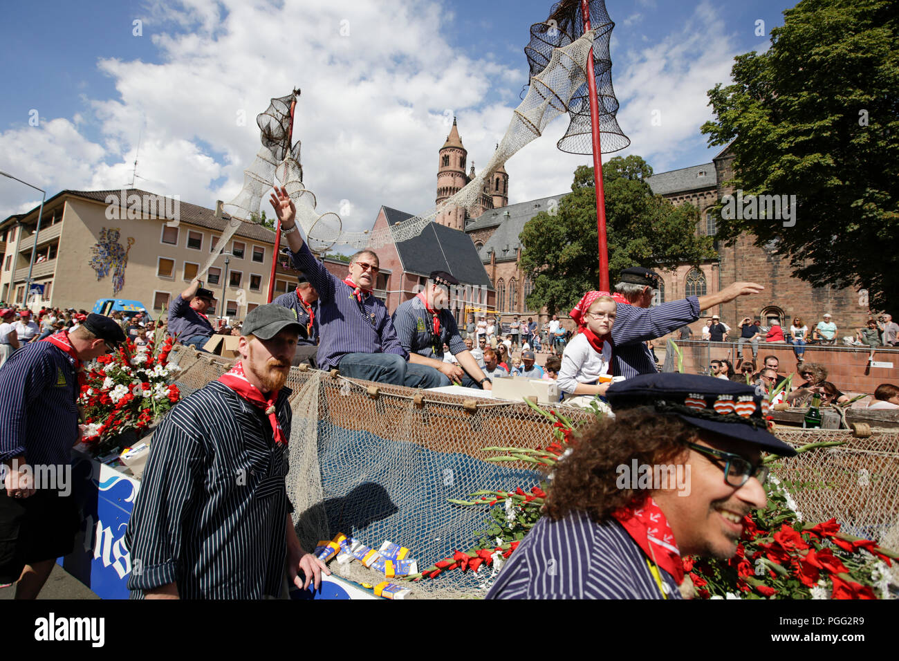 Worms, Germany. 26th August 2018. Members of the old fishermen's guild of Worms ride in a fishing boat in the parade. The first highlight of the 2018 Backfischfest was the big parade through the city of Worms with over 70 groups and floats. Community groups, music groups and businesses from Worms and further afield took part. Credit: Michael Debets/Alamy Live News Stock Photo