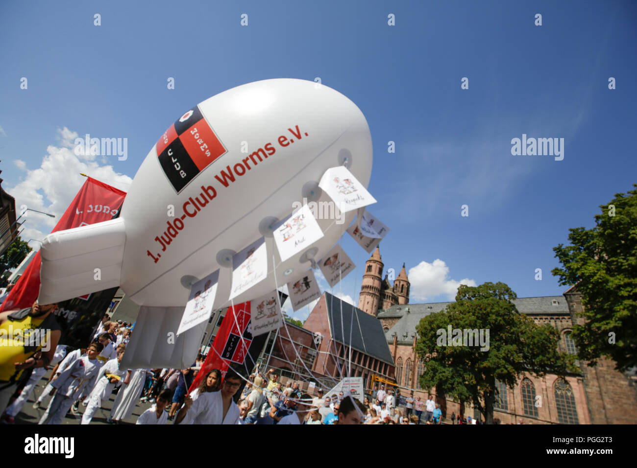 Worms, Germany. 26th August 2018. Members of the Judo-Club Worms carries a small air-filled Zeppelin in the parade. The first highlight of the 2018 Backfischfest was the big parade through the city of Worms with over 70 groups and floats. Community groups, music groups and businesses from Worms and further afield took part. Credit: Michael Debets/Alamy Live News Stock Photo