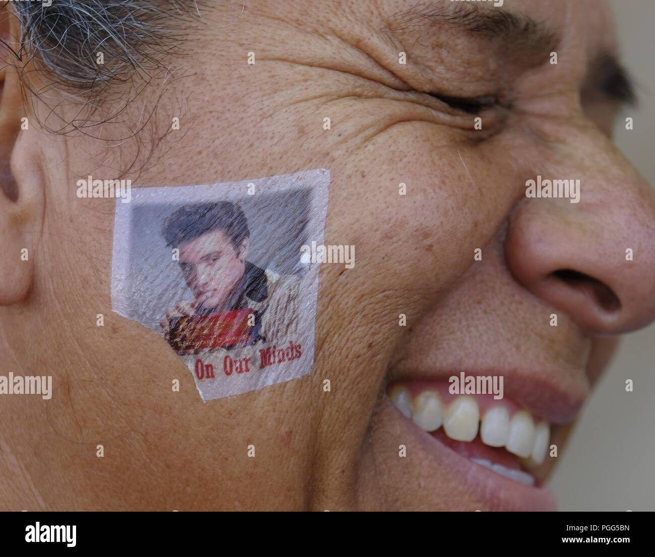 Los Angeles, California, USA. 26th Aug, 2018. An Elvis fan with a temporary  tattoo on her face participates in the 19th annual Elvis Festival to  tribute the King of Rock N' Roll,
