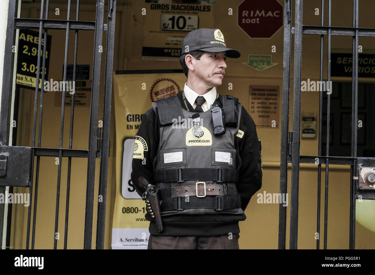 Security guard at entrance to money exchange in Miraflores, Lima, Peru Stock Photo