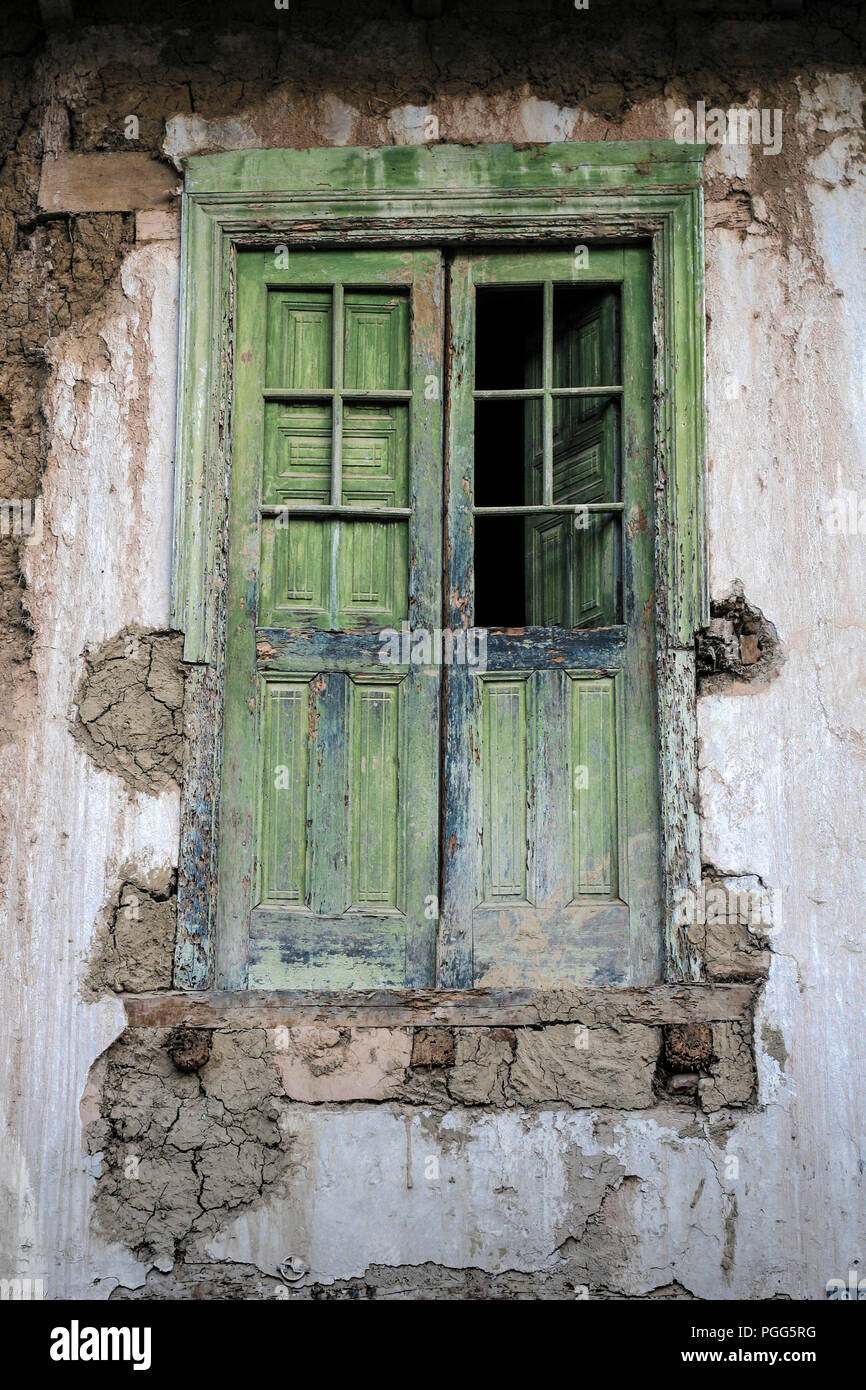 Old green wooden doors in old adobe building Stock Photo
