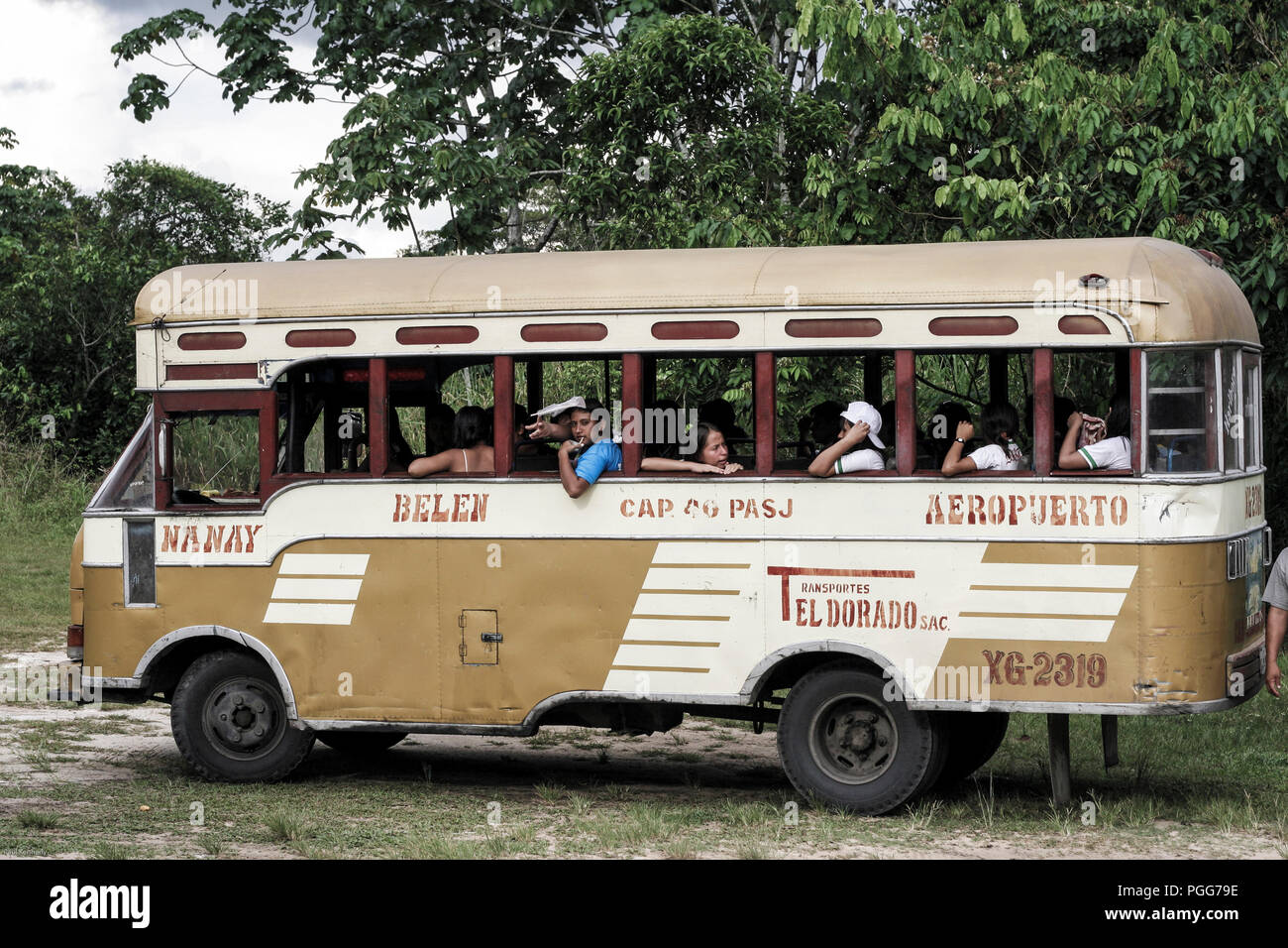 Old open air bus with passengers in Iquitos, Peru Stock Photo